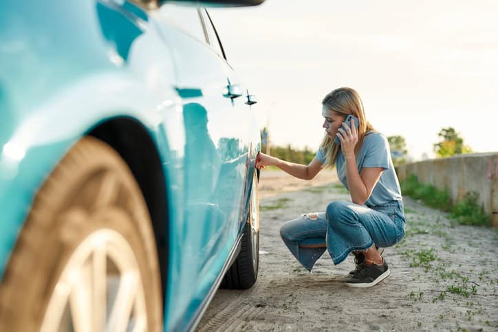 Attractive young woman looking sad, calling car service